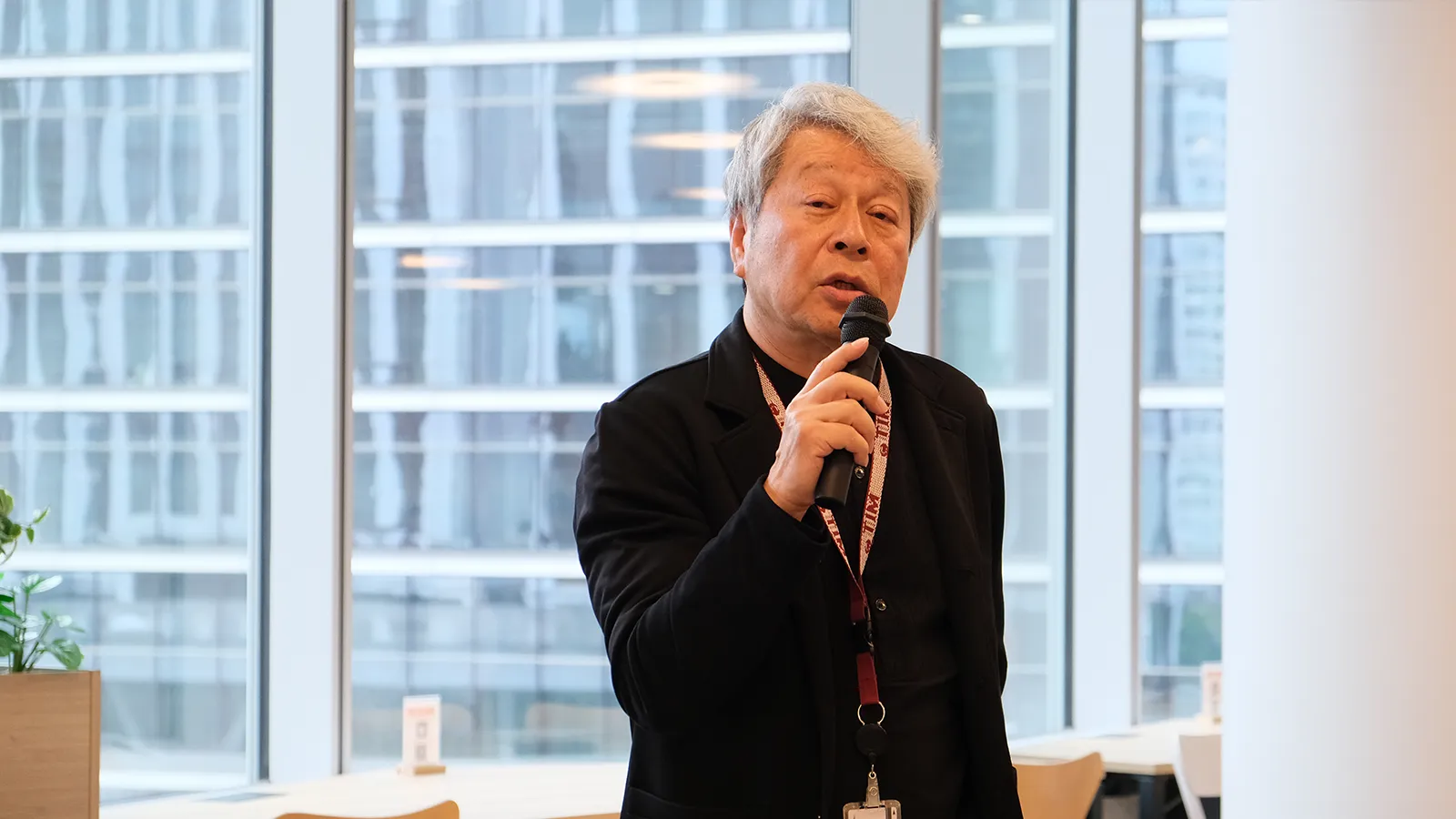 窓を背に話す井上さん