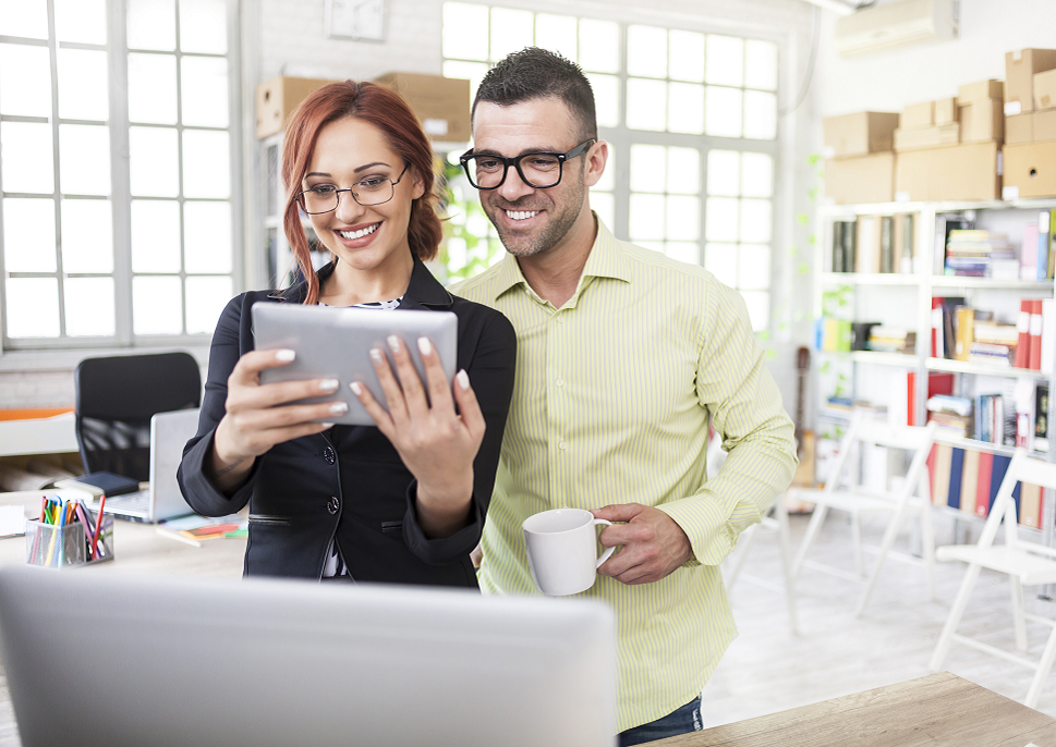 colleagues working on a mobile device in a small medium business