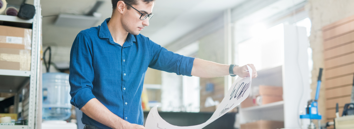 Man Examining Sustainably Printed Collateral