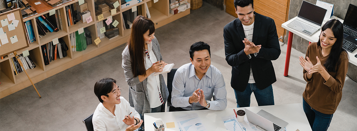 Young professional communicating with coworkers at a virtual meeting.