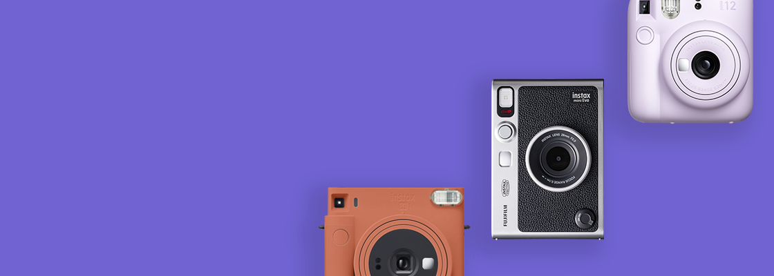 [photo] 3 INSTAX cameras in different colors over a purple background
